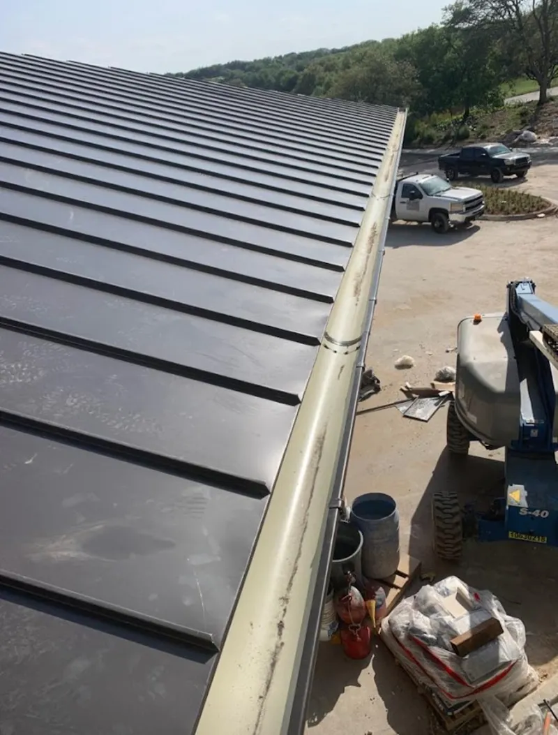 Standing seam panel and gutter detail on a metal roofing jobsite in Dublin